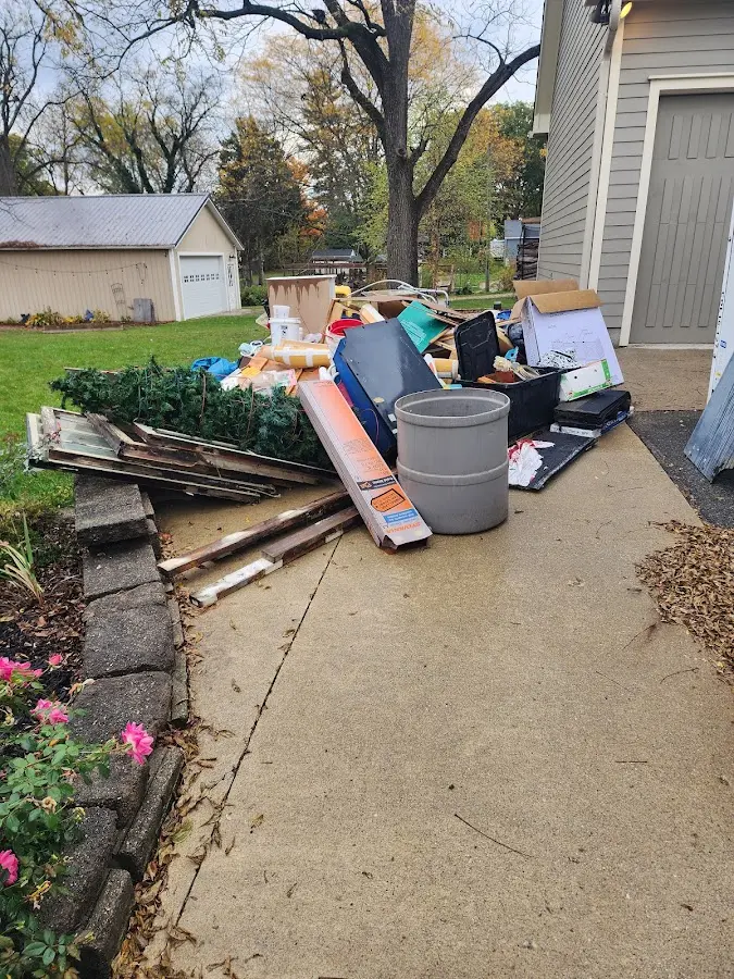 Dumpster being loaded with debris for 12 Yard Dumpster Rental in Coalinga